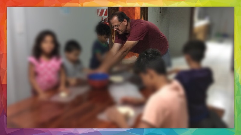 John teaching some of the kids how to make tortillas